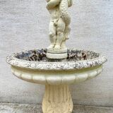 Beautiful old stone garden fountain with child statue