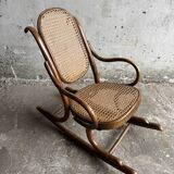 Warm walnut bentwood and cane child's rocking chair early 20th-century