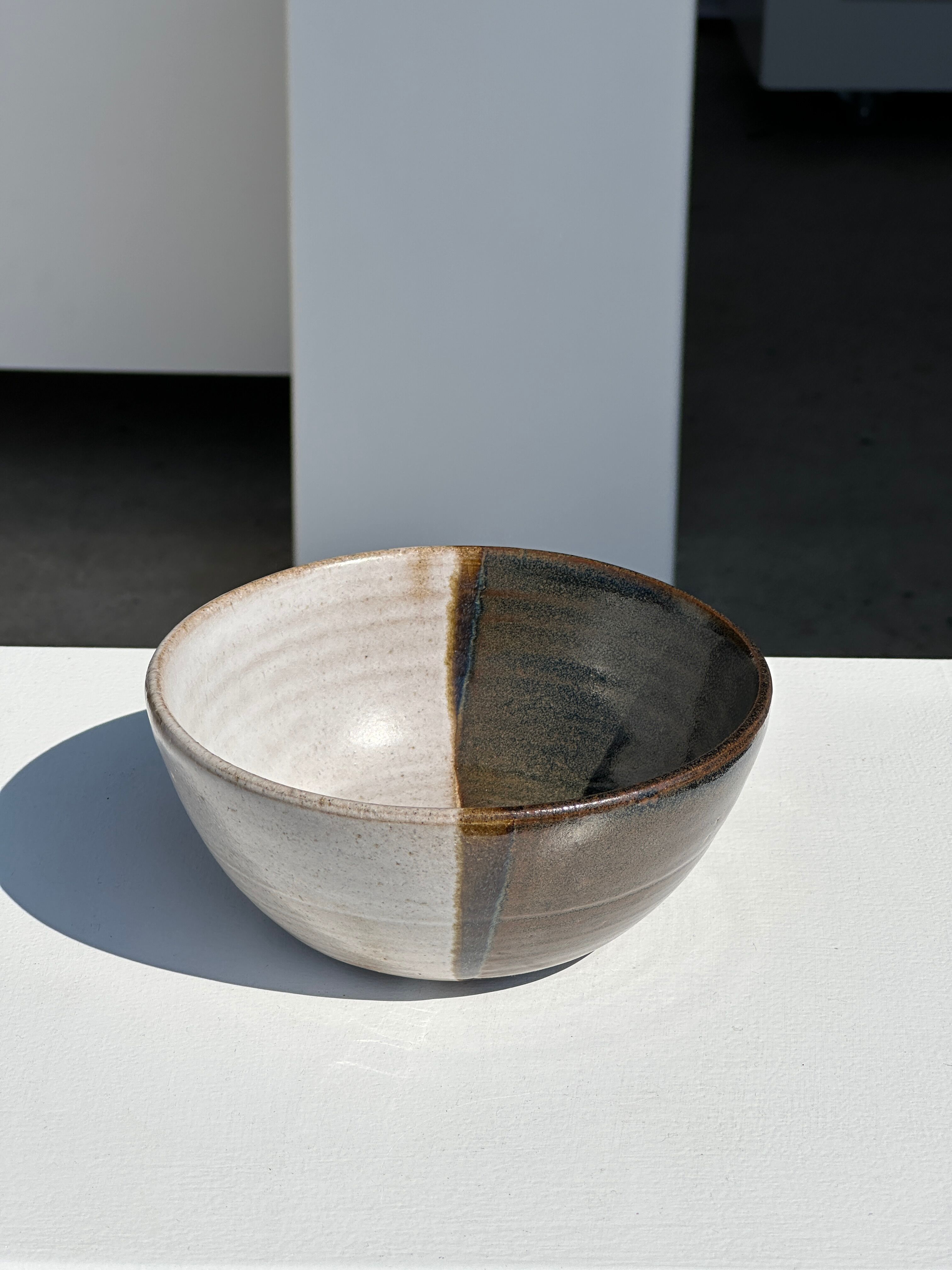 White and glossy brown two-tone ceramic bowl, matt earth