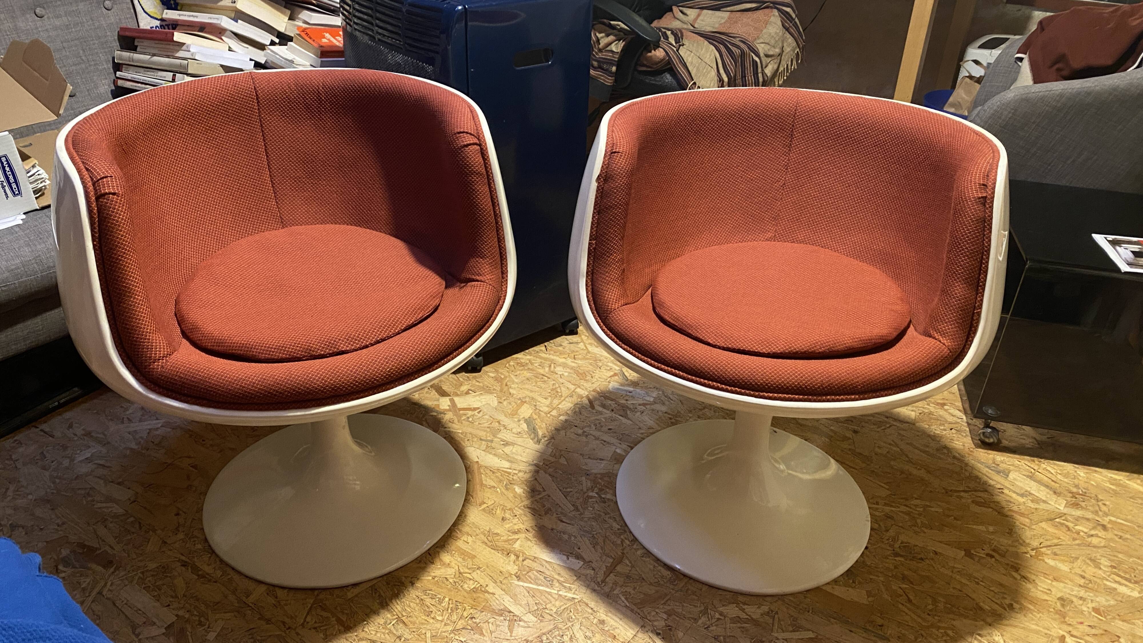 Two cognac-colored swivel chairs made of fiberglass from the 1970s