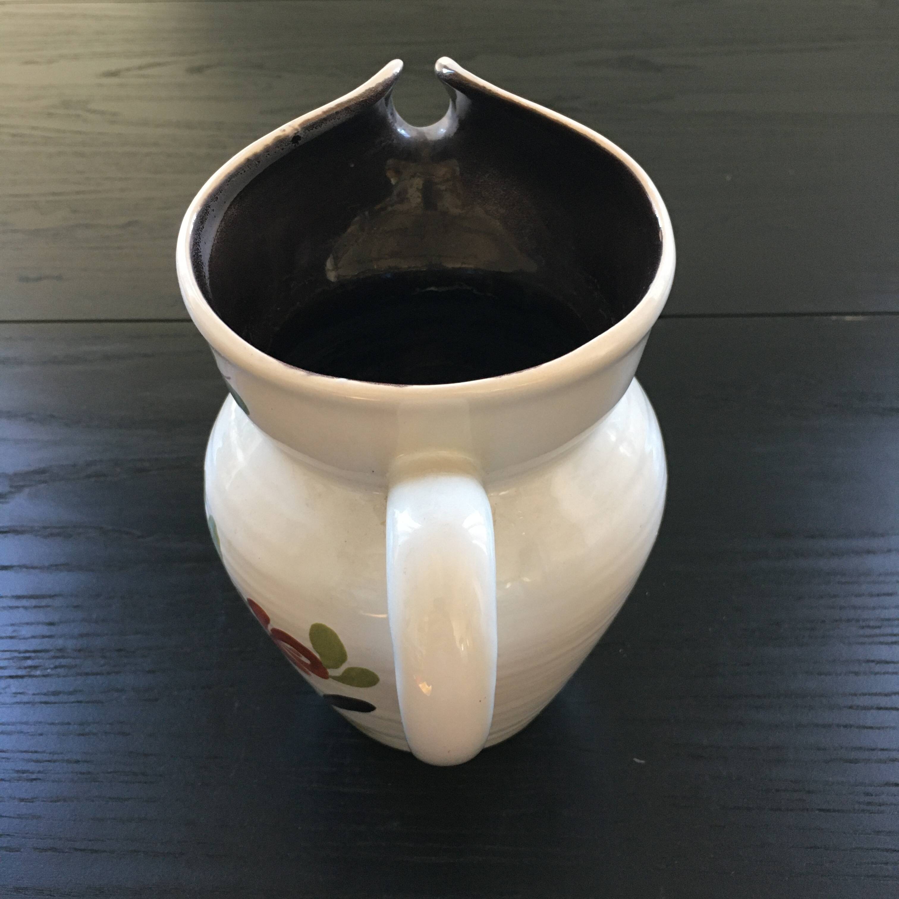 White pitcher with floral decoration