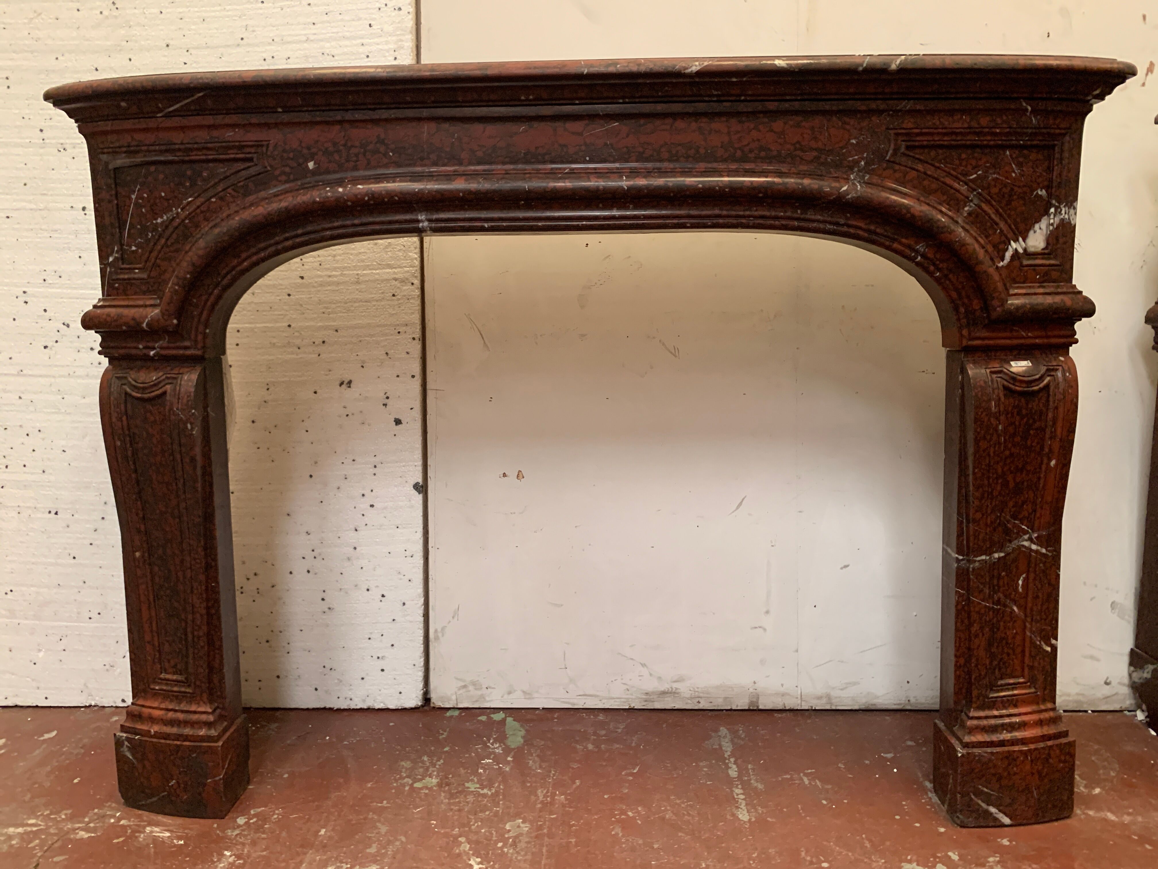 Pair of Louis XIV style fireplaces in red cherry marble. XIX century.