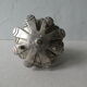 Silver-coloured metal pine cone candlestick
