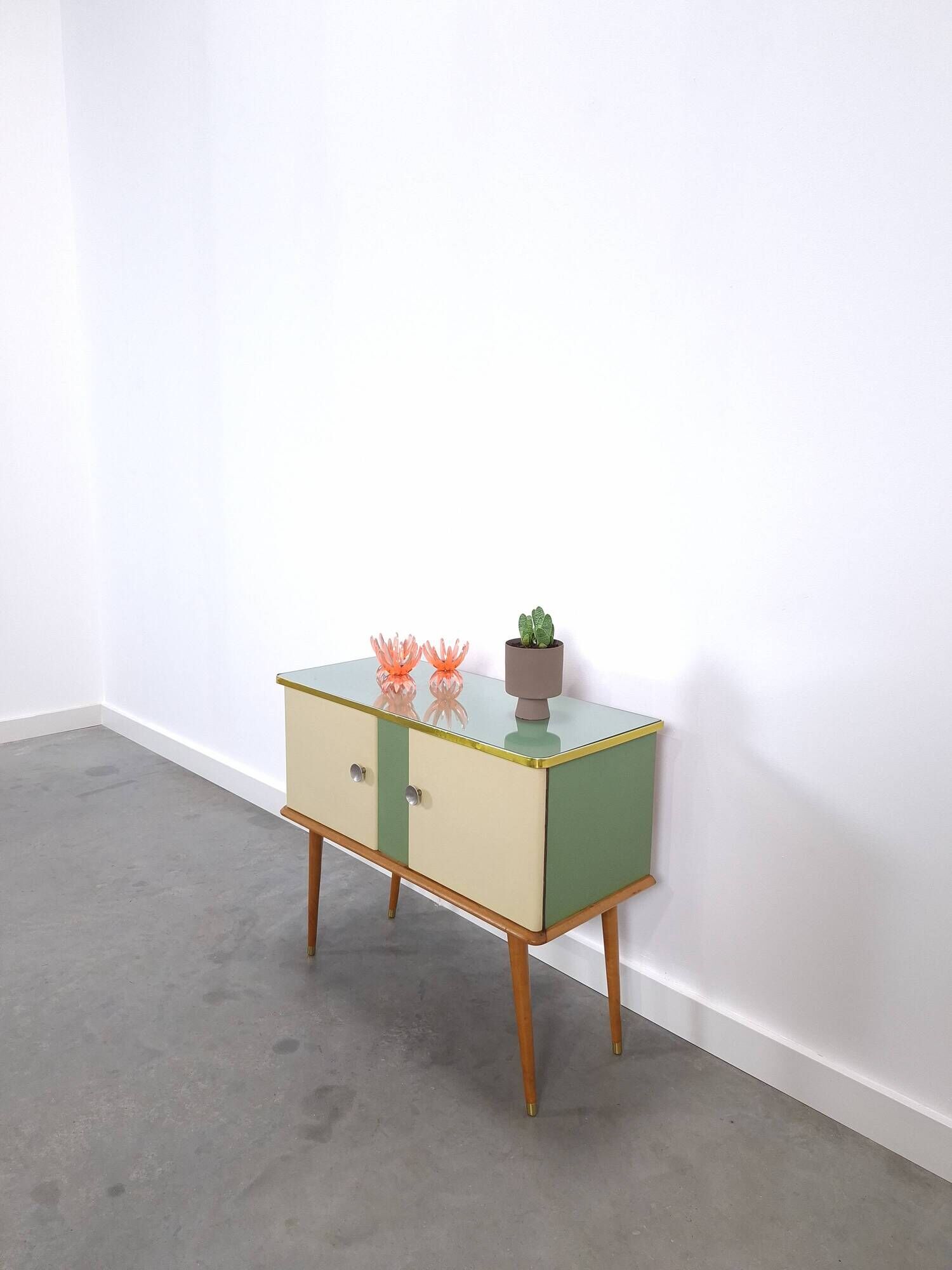 Vintage green DDR cabinet, model Libelle with glass top, slanted legs.