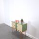 Vintage green DDR cabinet, model Libelle with glass top, slanted legs.