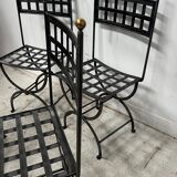 Set of four wrought iron chairs, with a reclining X-shaped base, seat and backrest.