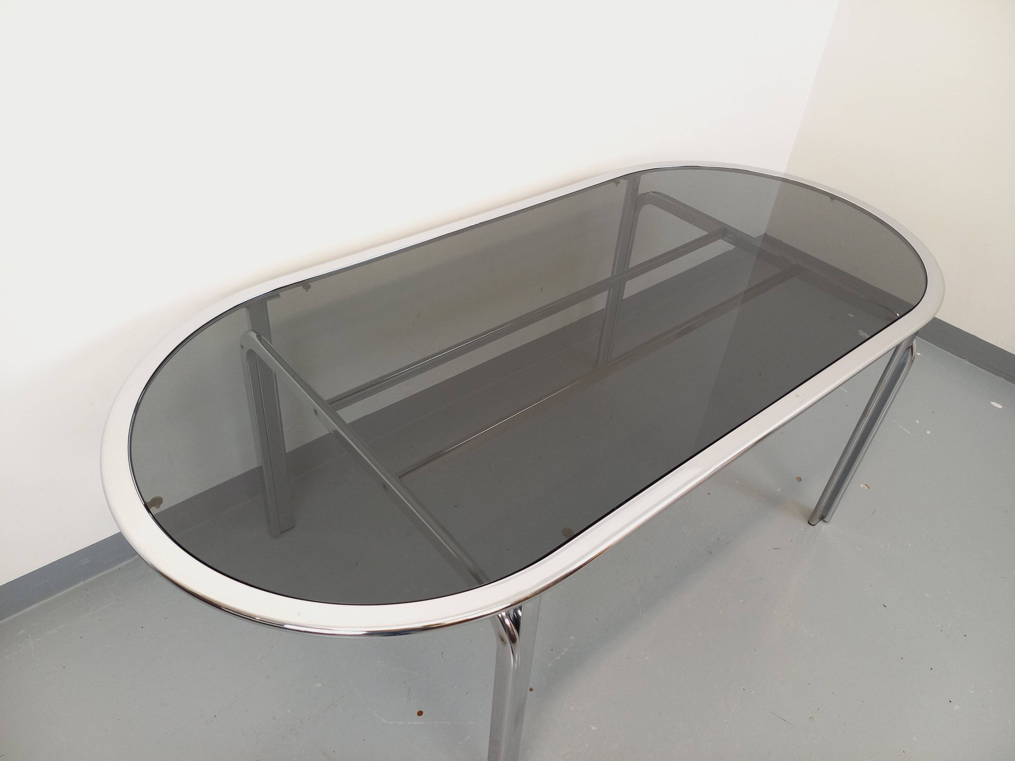 Vintage oval dining table in smoked glass and chrome metal, Space Age style.