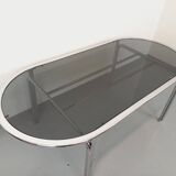 Vintage oval dining table in smoked glass and chrome metal, Space Age style.