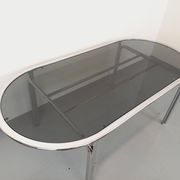 Vintage oval dining table in smoked glass and chrome metal, Space Age style.