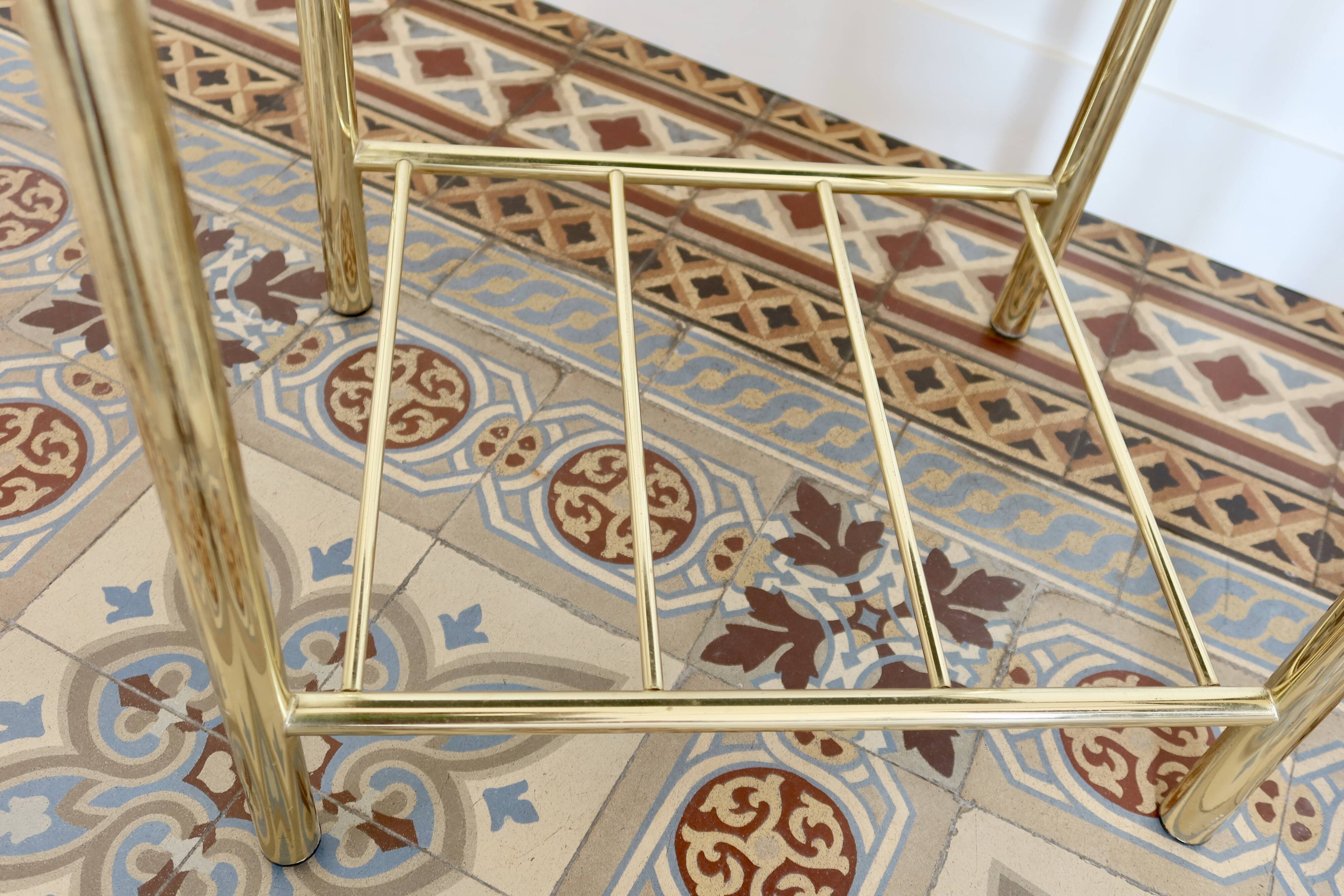 Pair of bedside tables with gold metal and mirrored glass top.