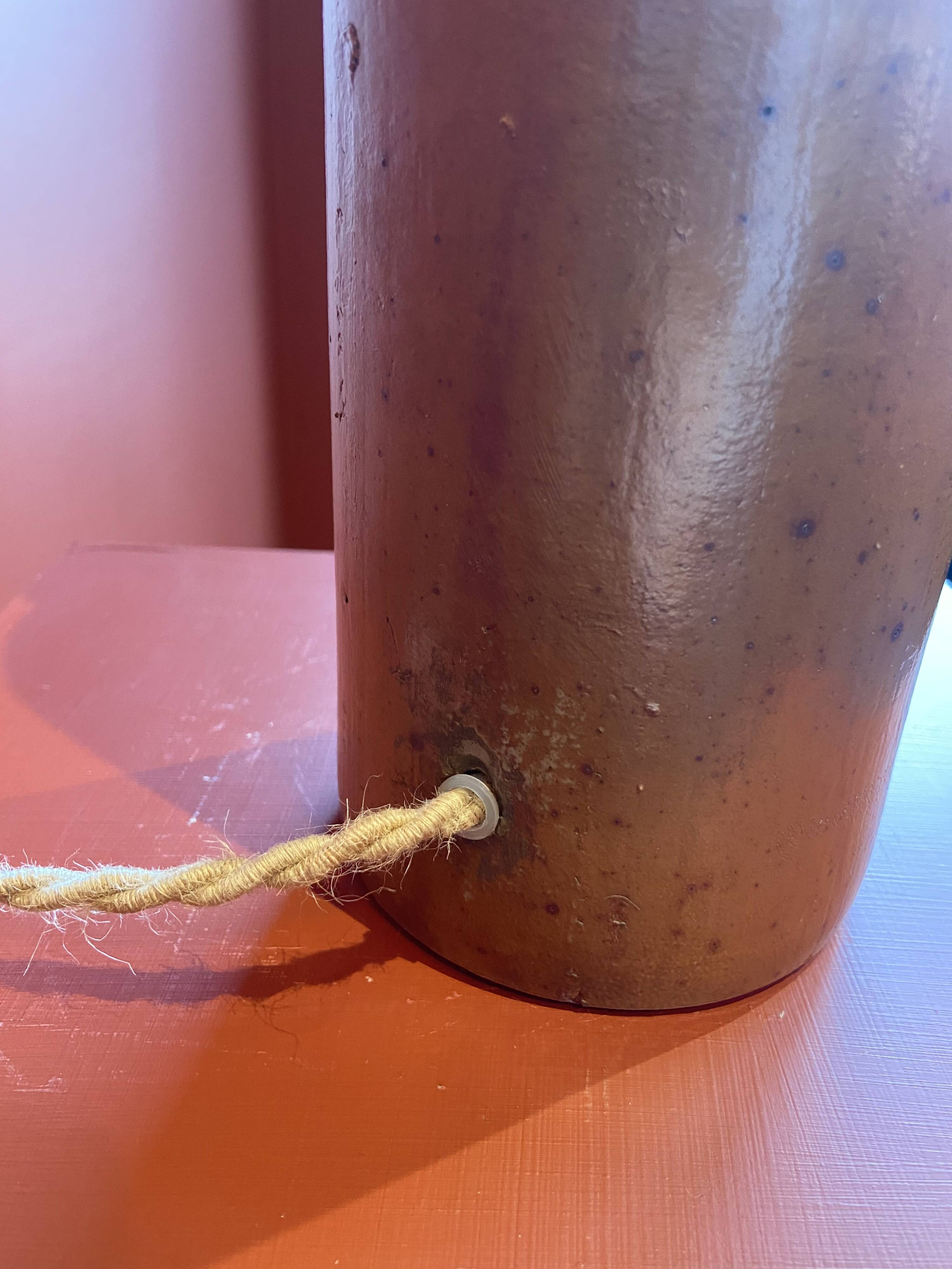 "Stoneware Bottle Lamp" with a multicoloured blue lampshade handwoven in India.