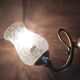Wall light with golden metal tulip support, pockmarked glass