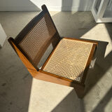Reclined armchair in canned teak in natural wood