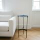 Vintage tripod metal side table with a blue brass bowl.