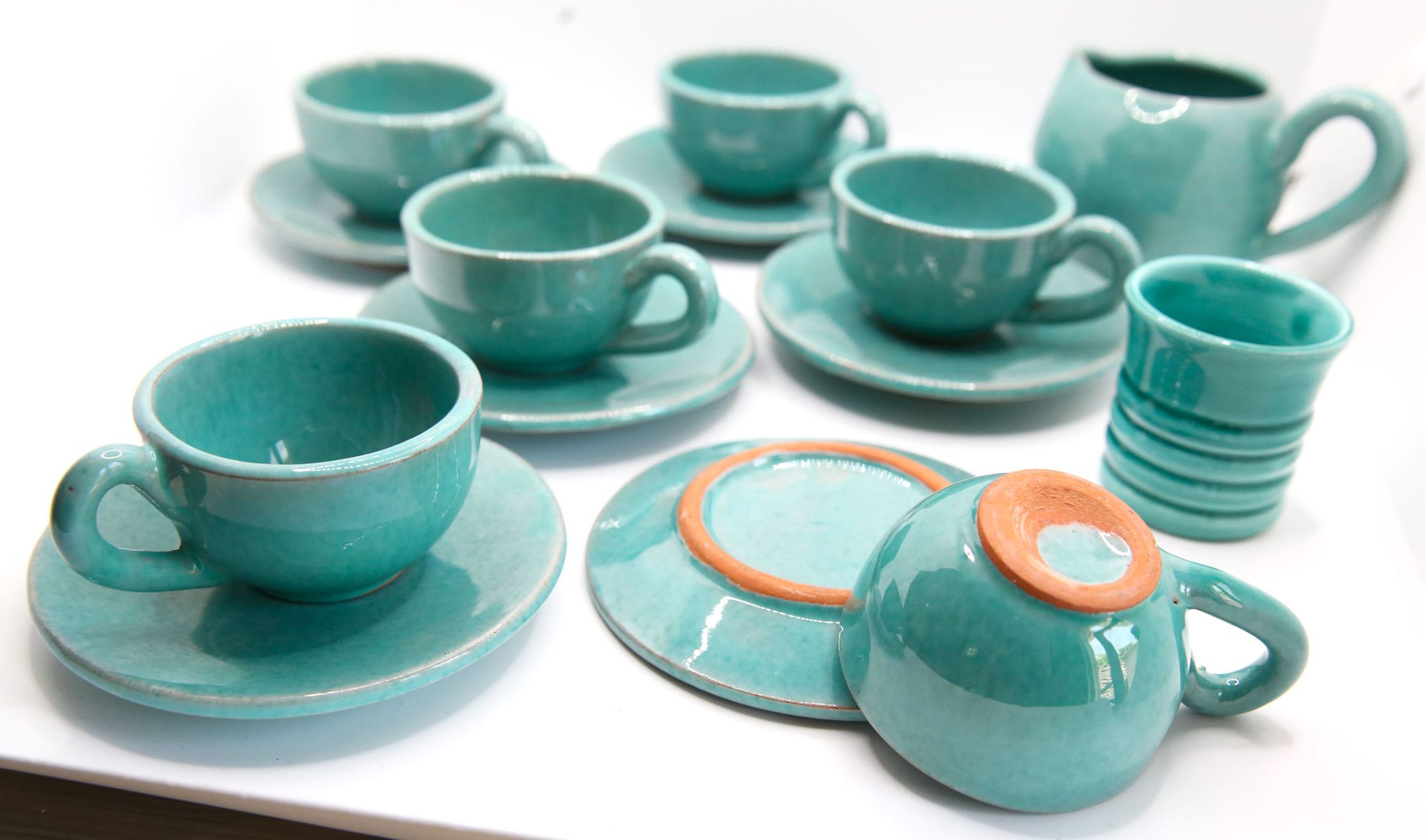 Set of 6 cups in turquoise blue enamelled earth with their saucers and milk jar