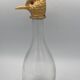 Glass bottle type carafe with gold metal bird head stopper