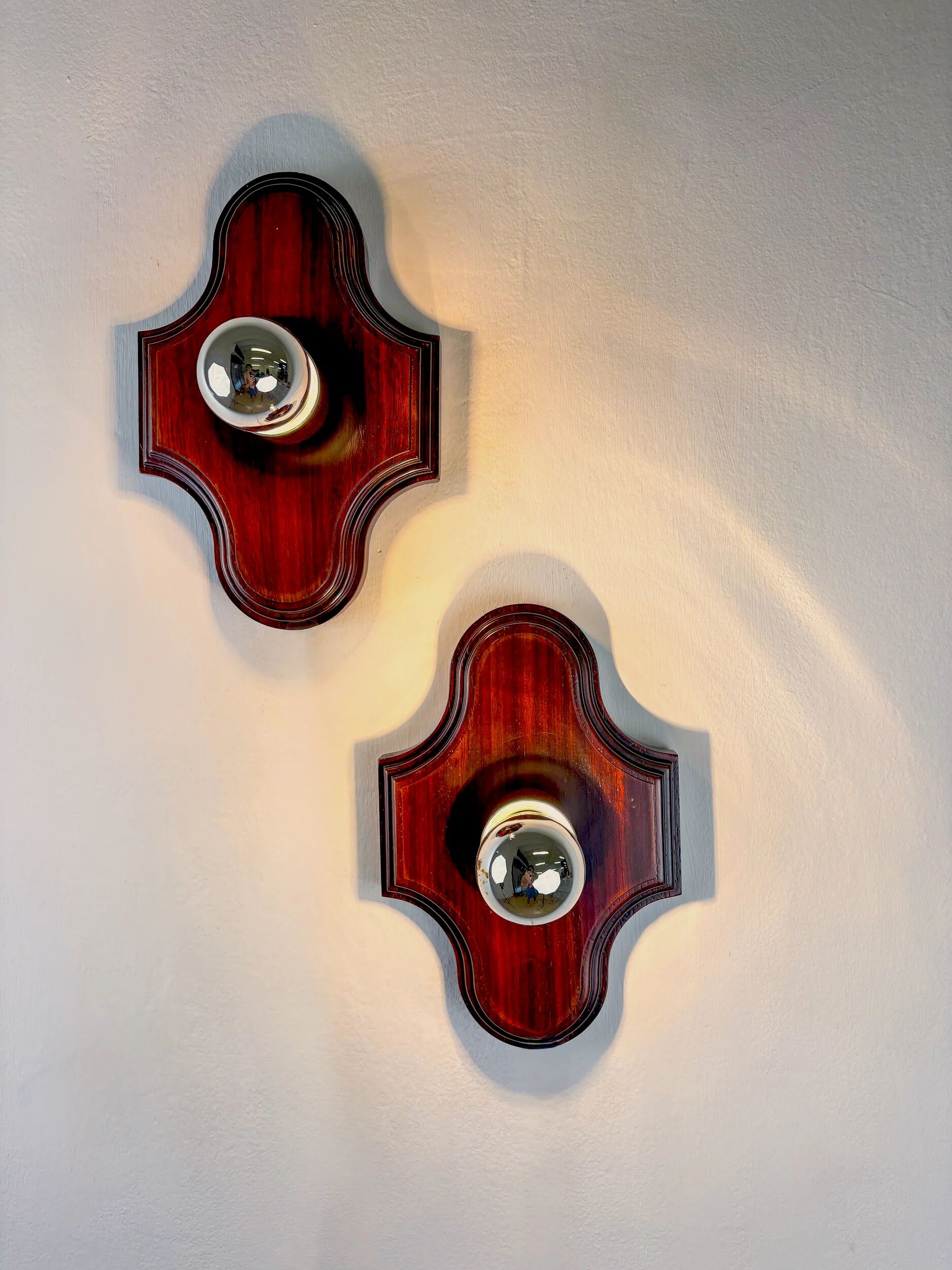 Pair of geometric Art Deco wall lights, carved wood, France, 1960s