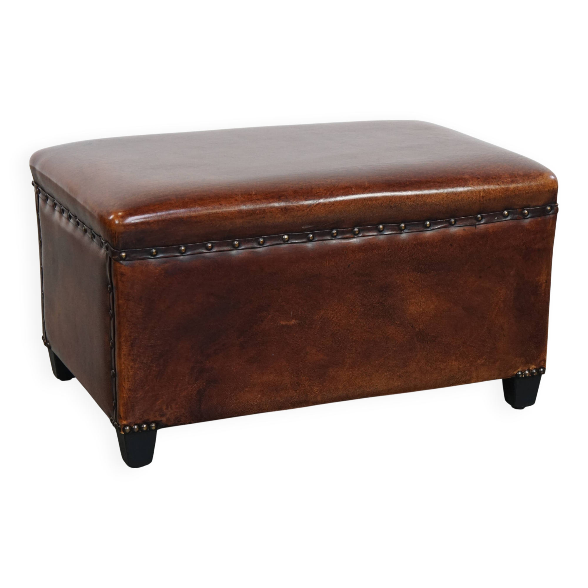 Cognac-colored sheepskin stool with decorative studs