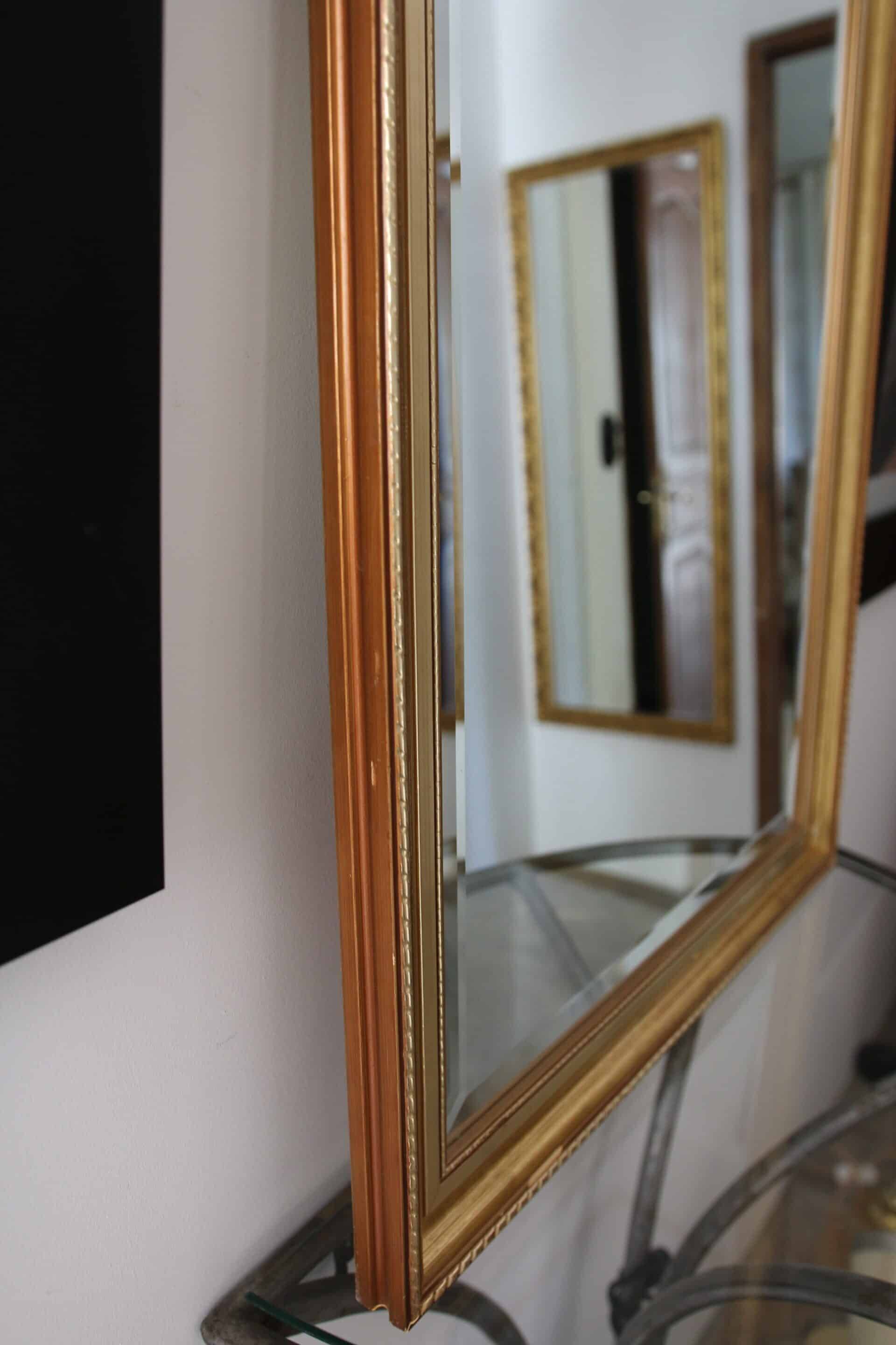 Large beveled mirror in carved wood