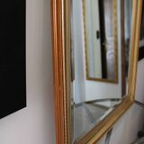 Large beveled mirror in carved wood