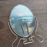 Vintage oval mirror on suspended stand
