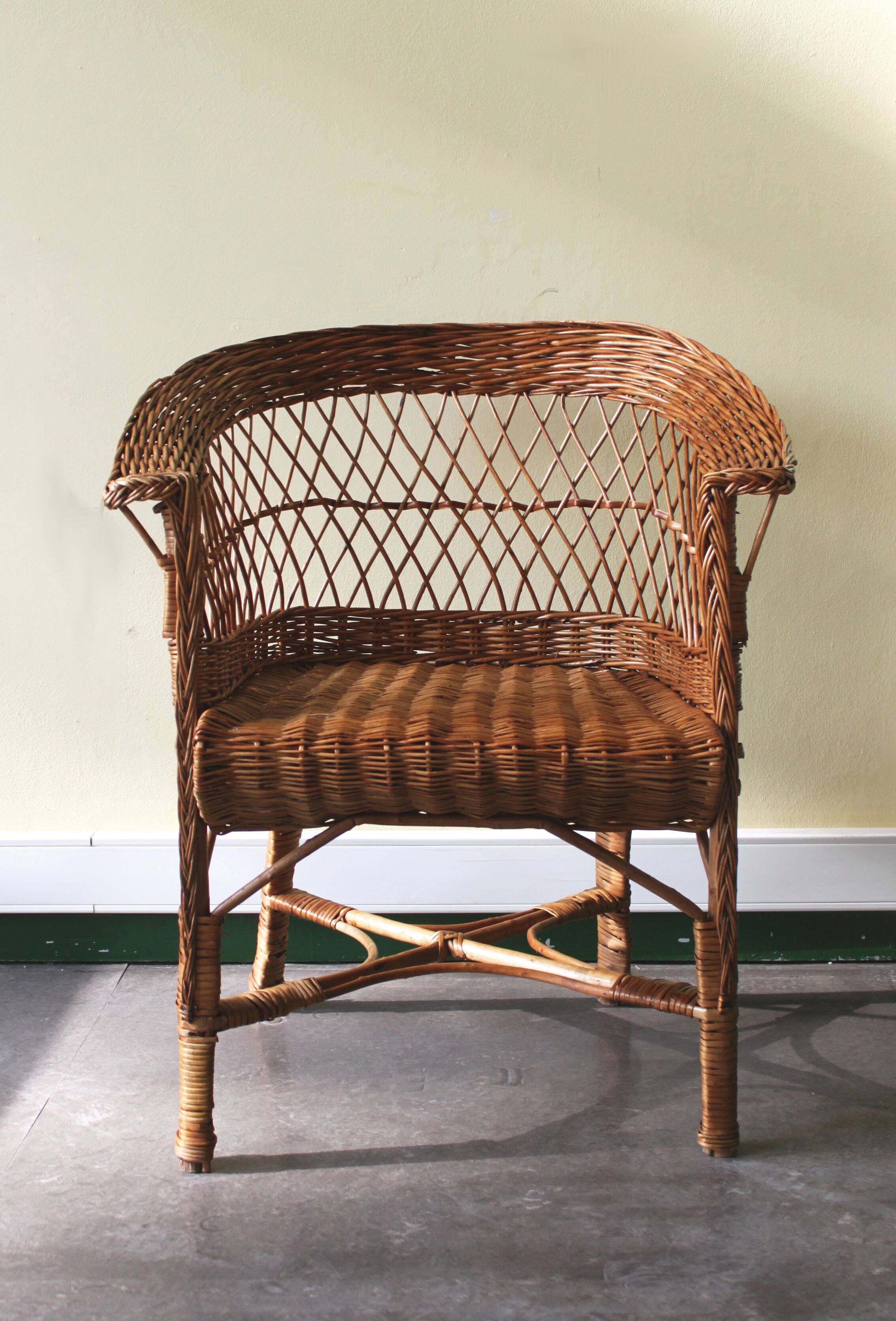 Woven rattan armchair with armrests.