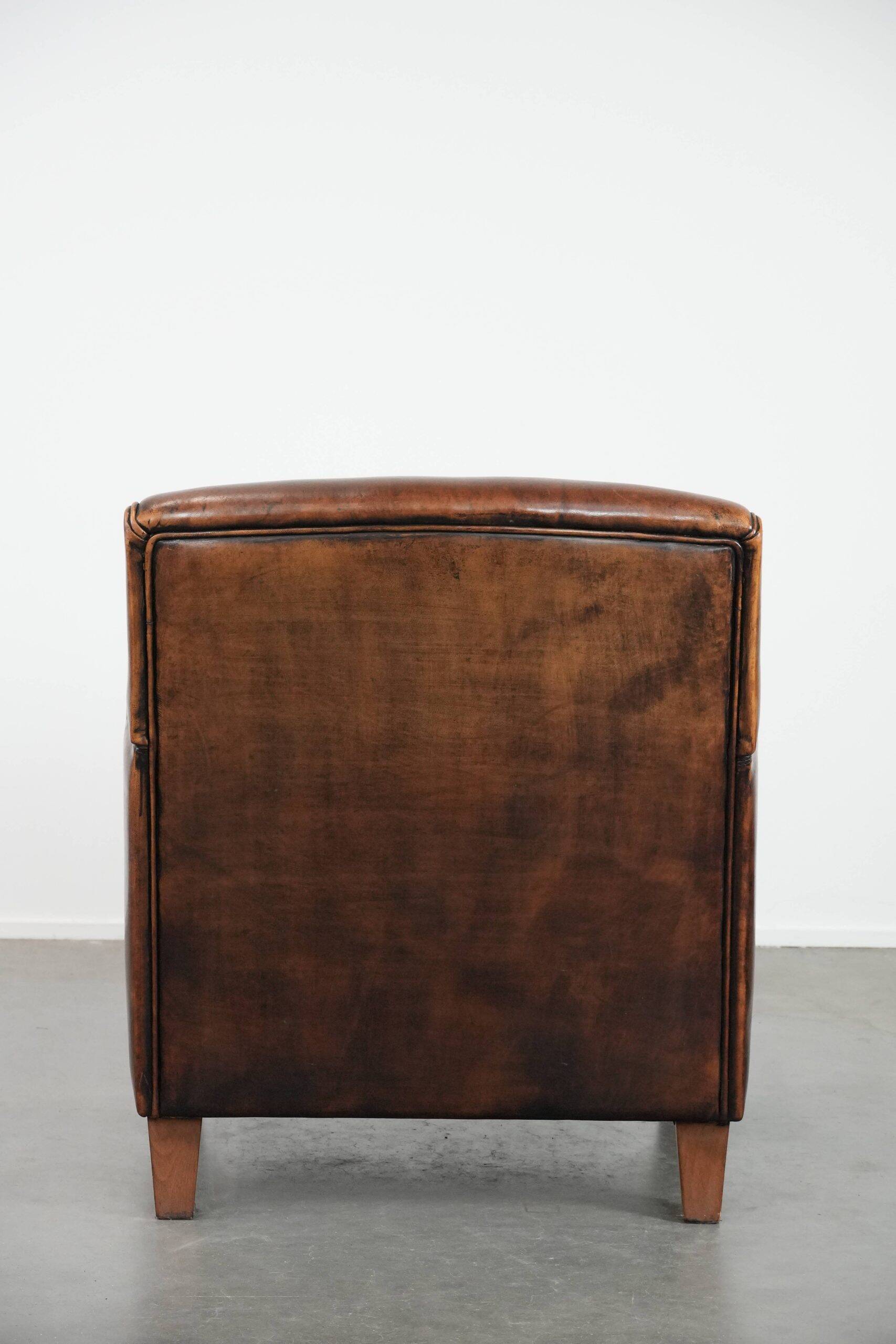 Beautifully shaped vintage sheepskin armchair with character