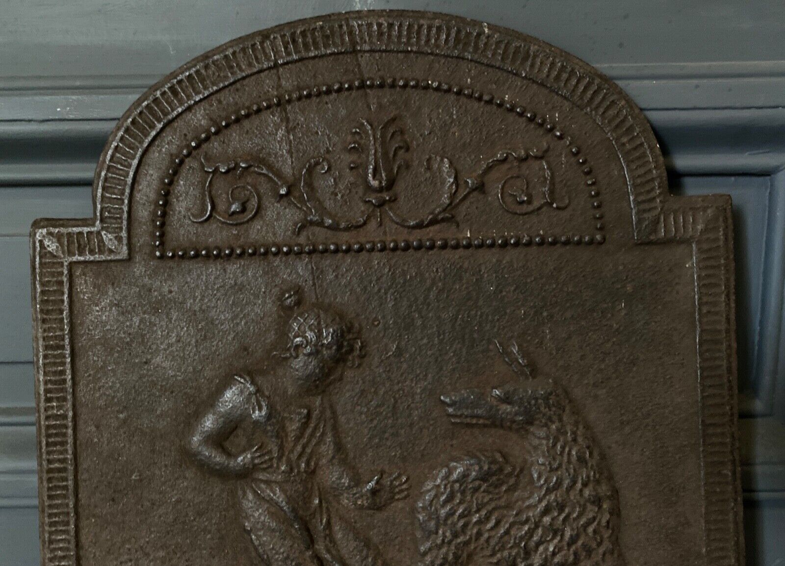 EIGHTEENTH CENTURY CAST IRON FIREPLACE PLATE REPRESENTING A WOMAN AND A WOLF
