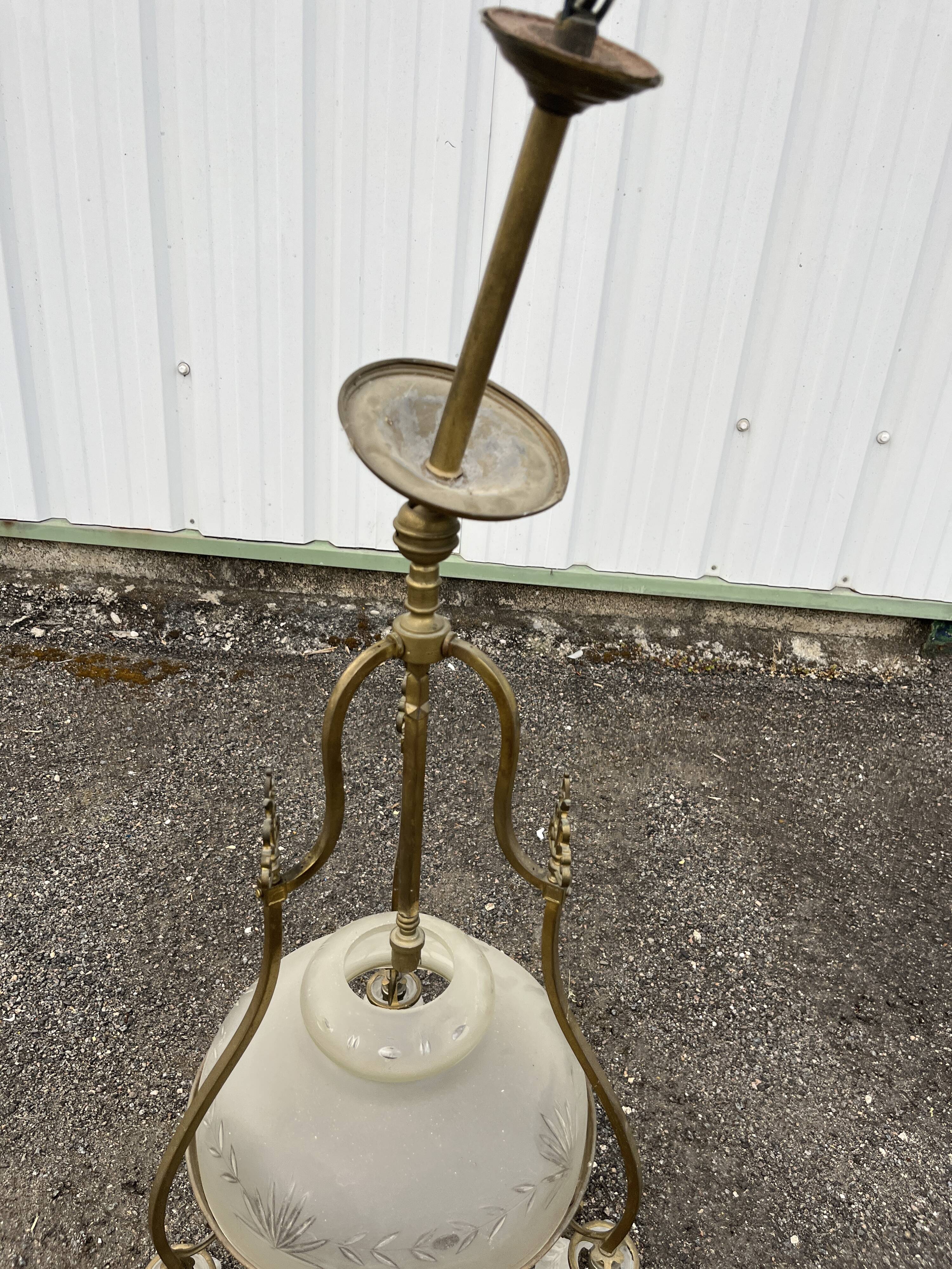 Antique brass chandelier with 3 lights and frosted glass shades.