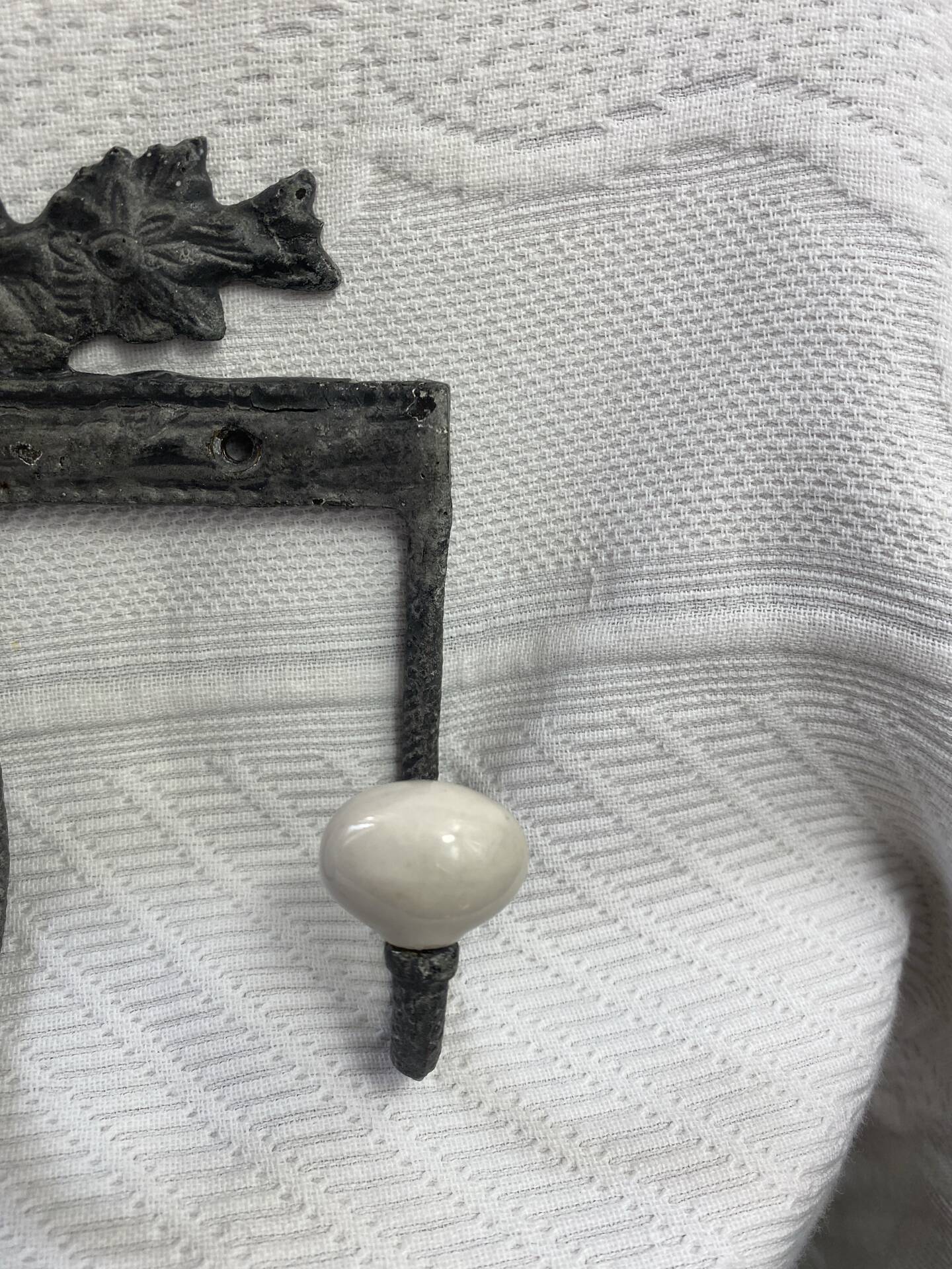 Patinated metal wall bracket and porcelain