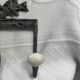 Patinated metal wall bracket and porcelain