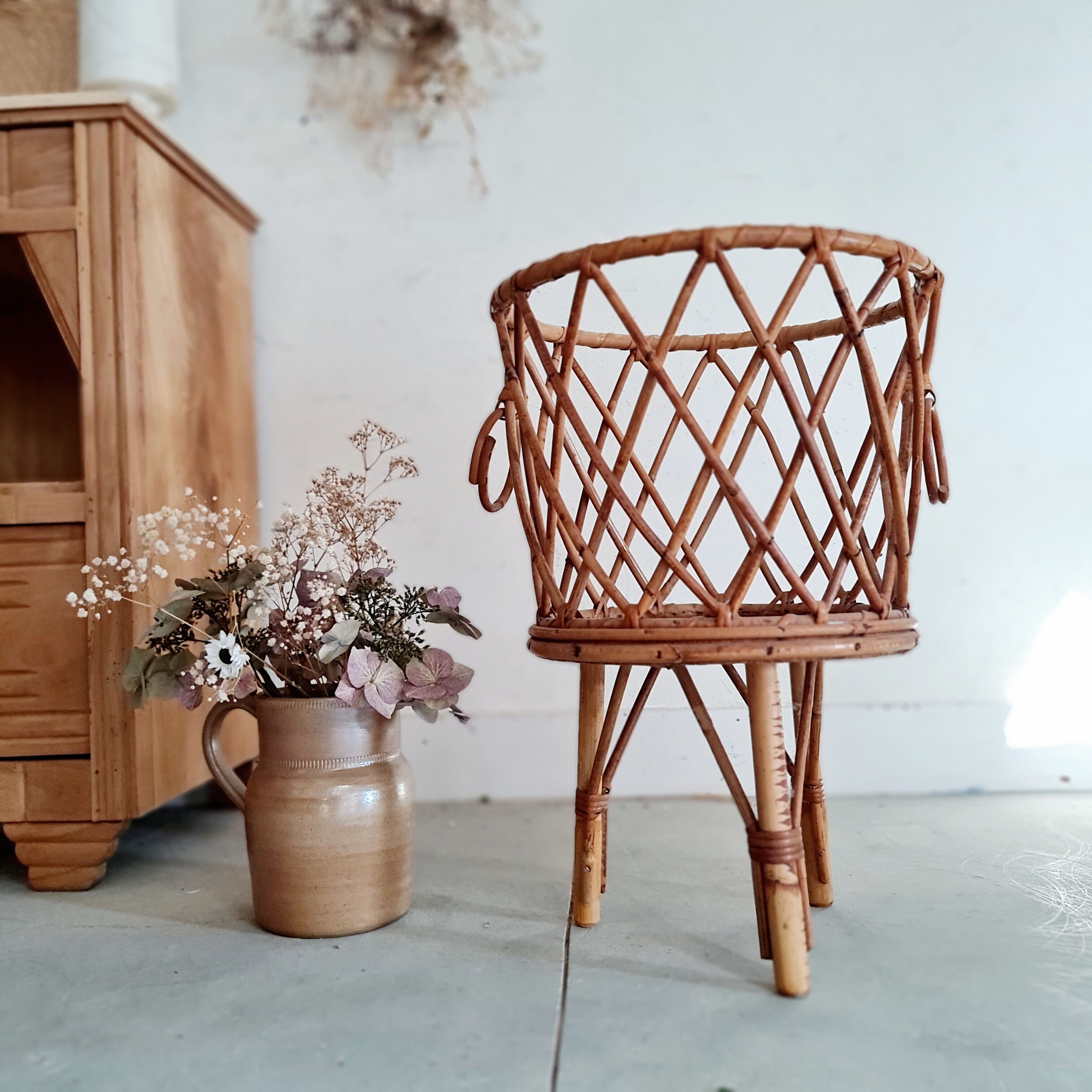 Old tripod rattan plant holder