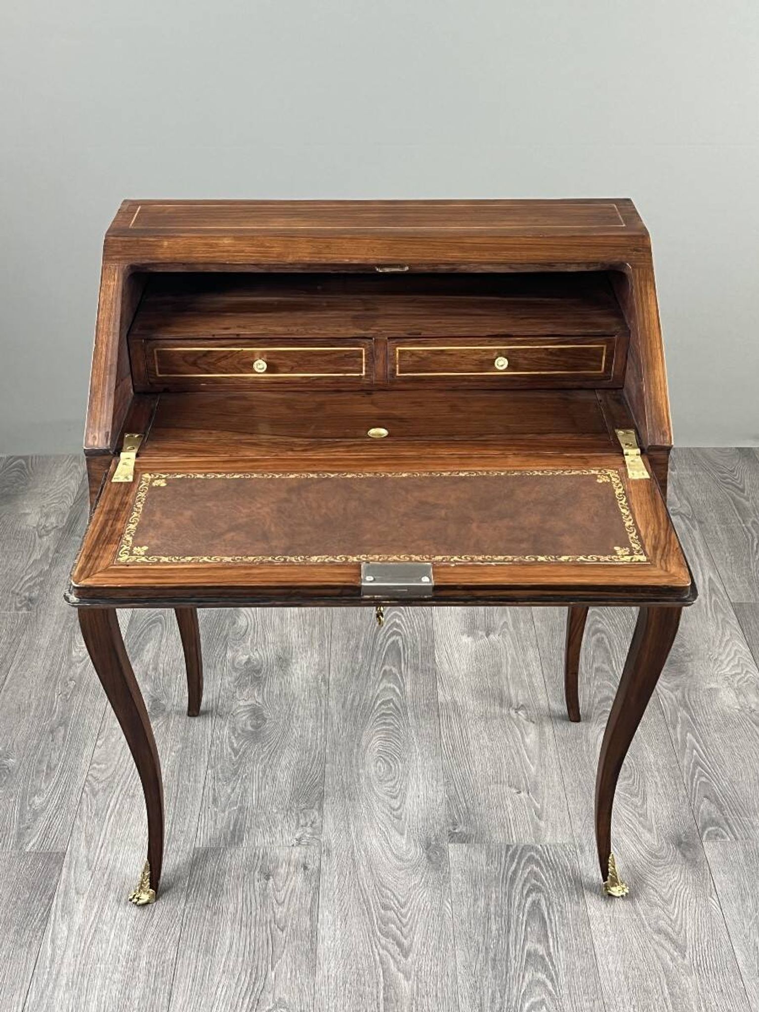 Secretary with a drop-down front in marquetry, Louis XV style, 19th century.