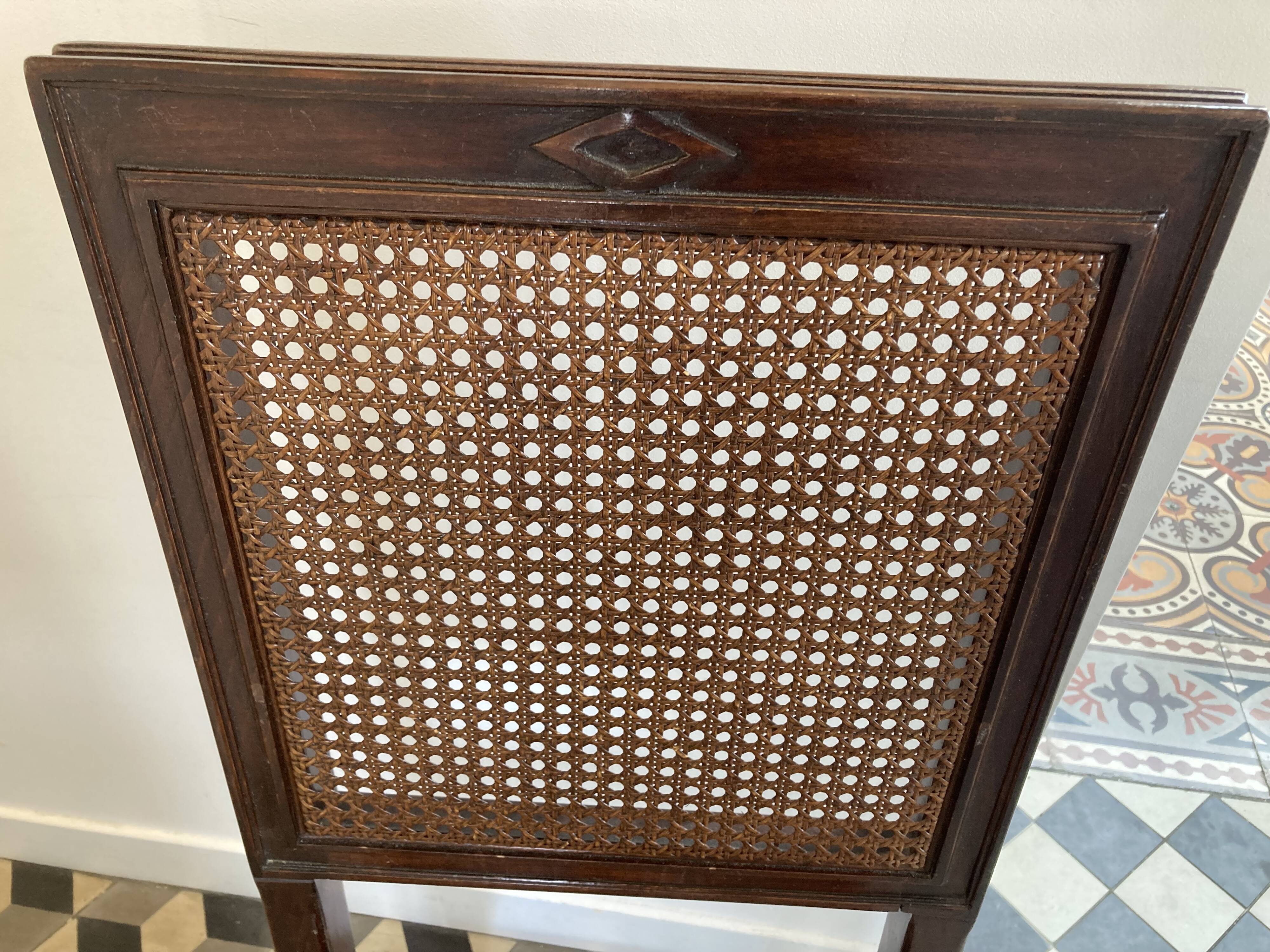 Vintage folding chair with cane seat in dark mahogany wood