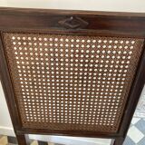 Vintage folding chair with cane seat in dark mahogany wood