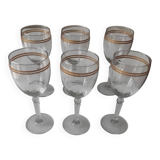 Set of 6 glasses with gold band decorations.