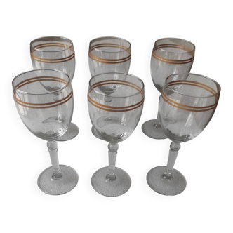Set of 6 glasses with gold band decorations.