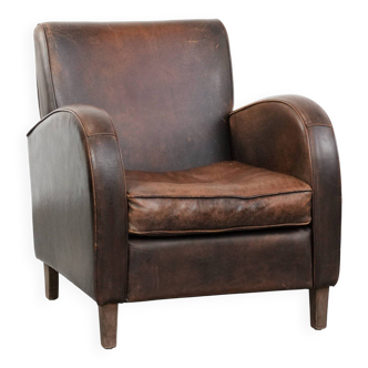 Timeless vintage sheepskin design armchair in a dark cognac colour