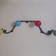 Vintage wall coat rack "Atomic" in wrought iron with multicoloured balls.