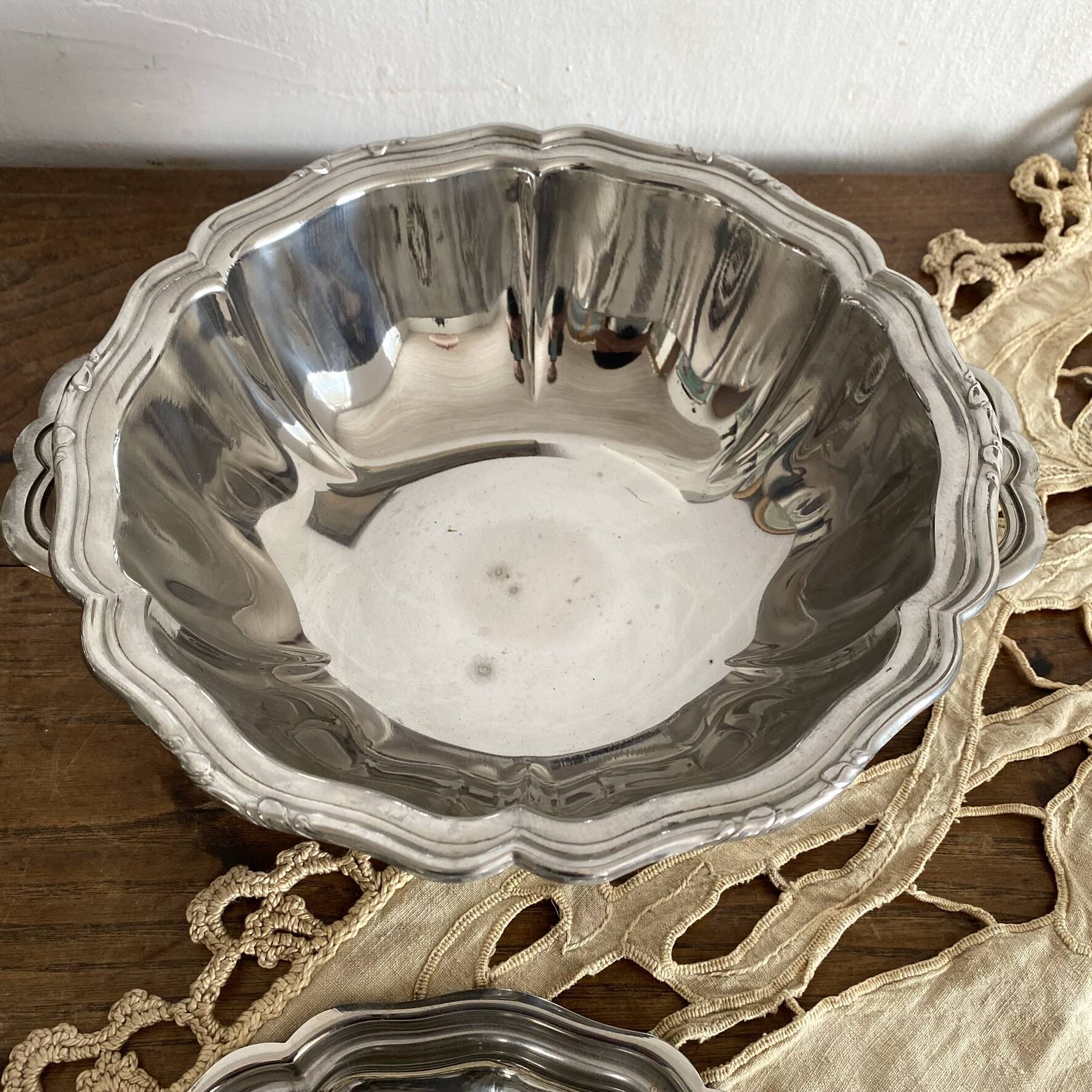 Vintage round stainless steel soup tureen with scalloped edges.