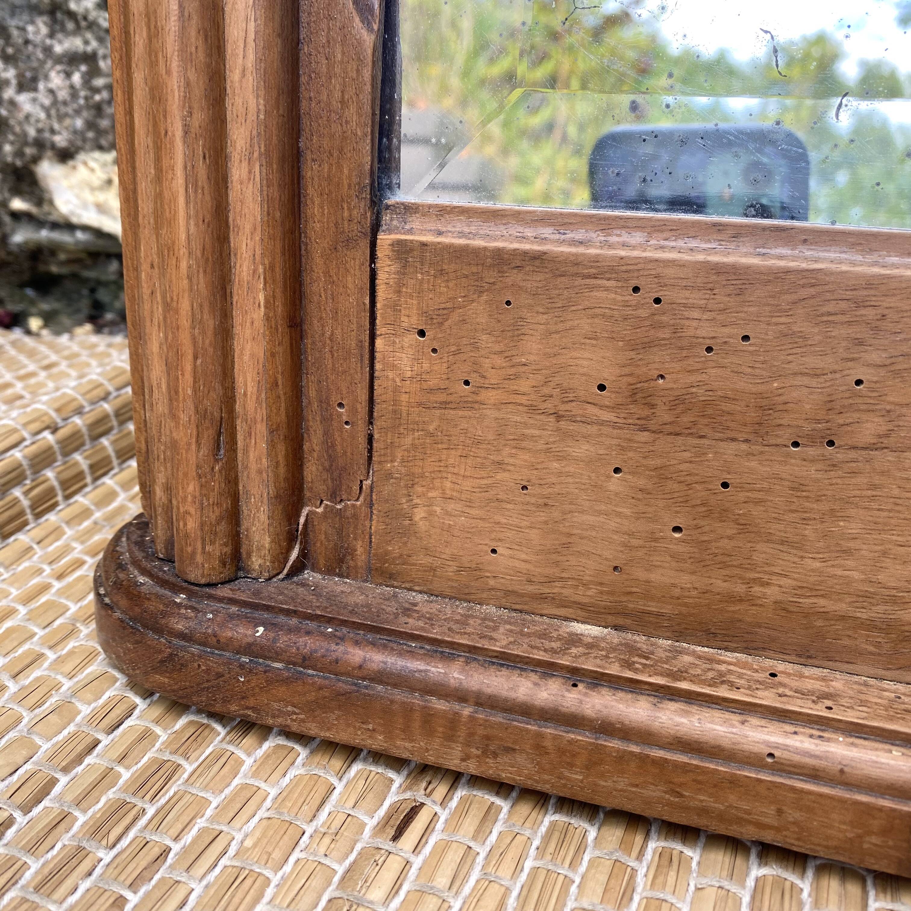Beveled art deco mirror, carved wood