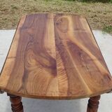 Round drop-leaf table made entirely of solid walnut