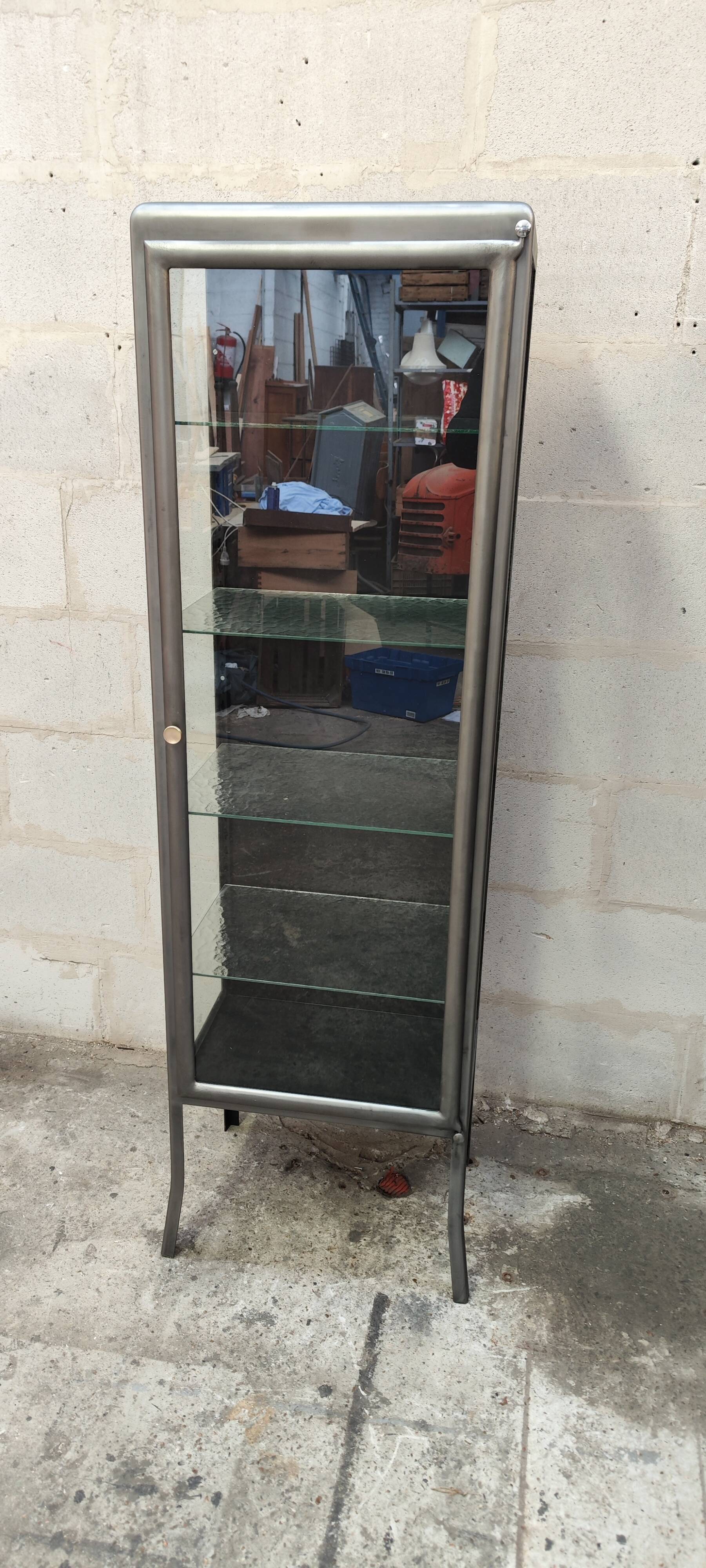 old medical display case with a graphite metal door