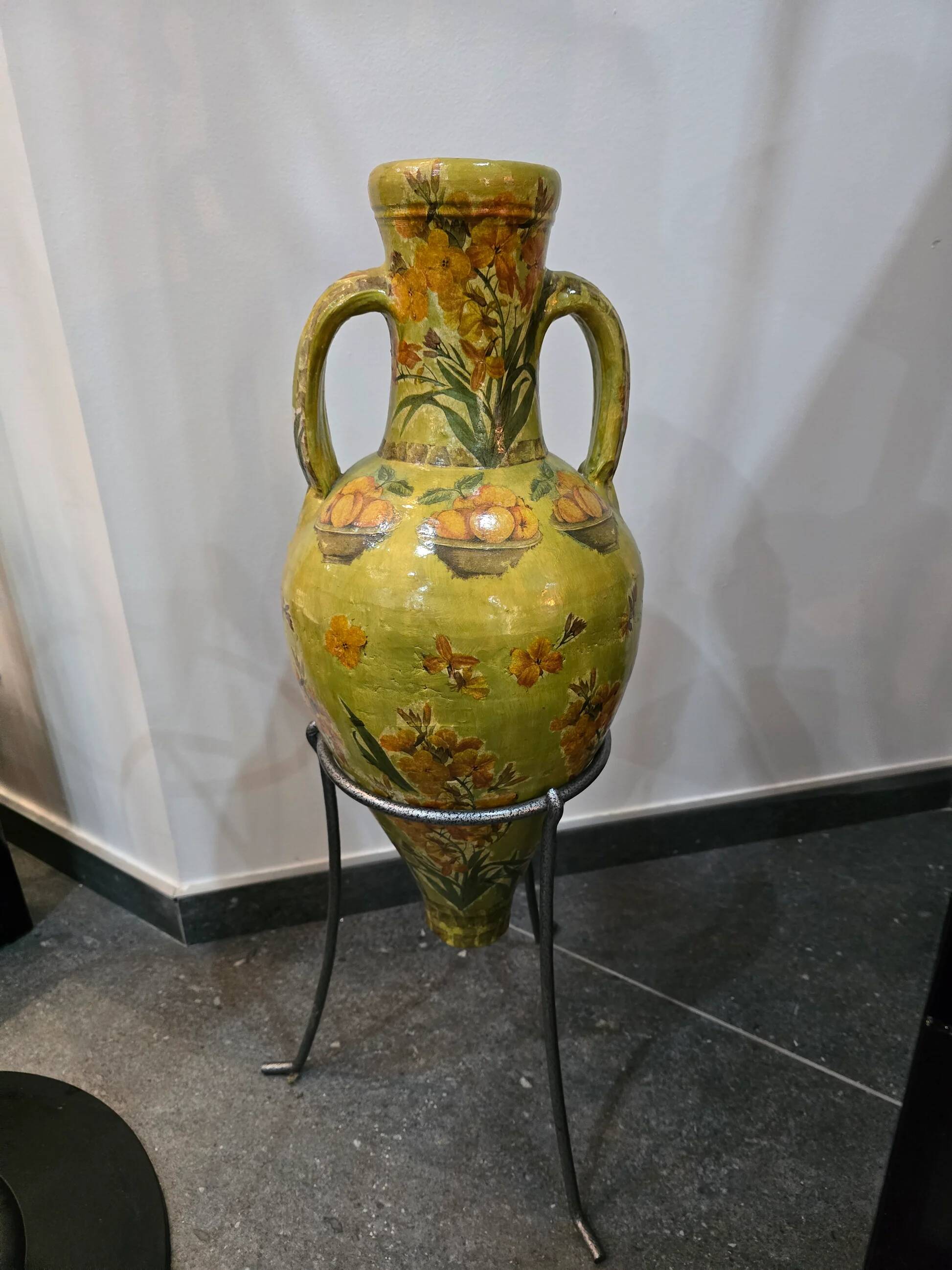 Large decorative vase with handles – painted floral design – on a metal stand