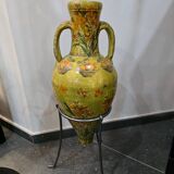 Large decorative vase with handles – painted floral design – on a metal stand