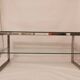 1980s coffee table with a double chrome metal top.