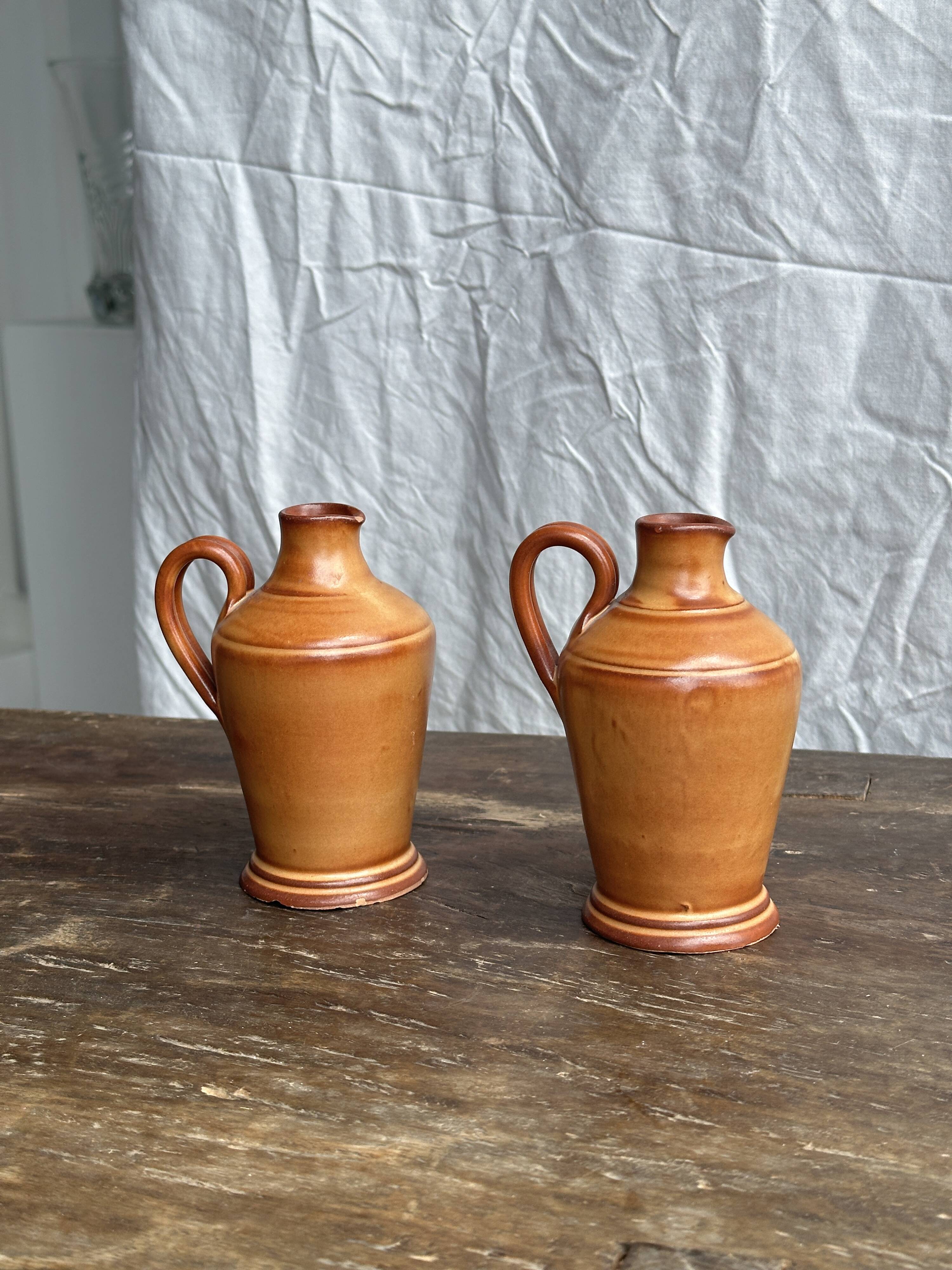 Pair of mini orange stoneware pitchers