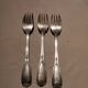 3 silver metal forks