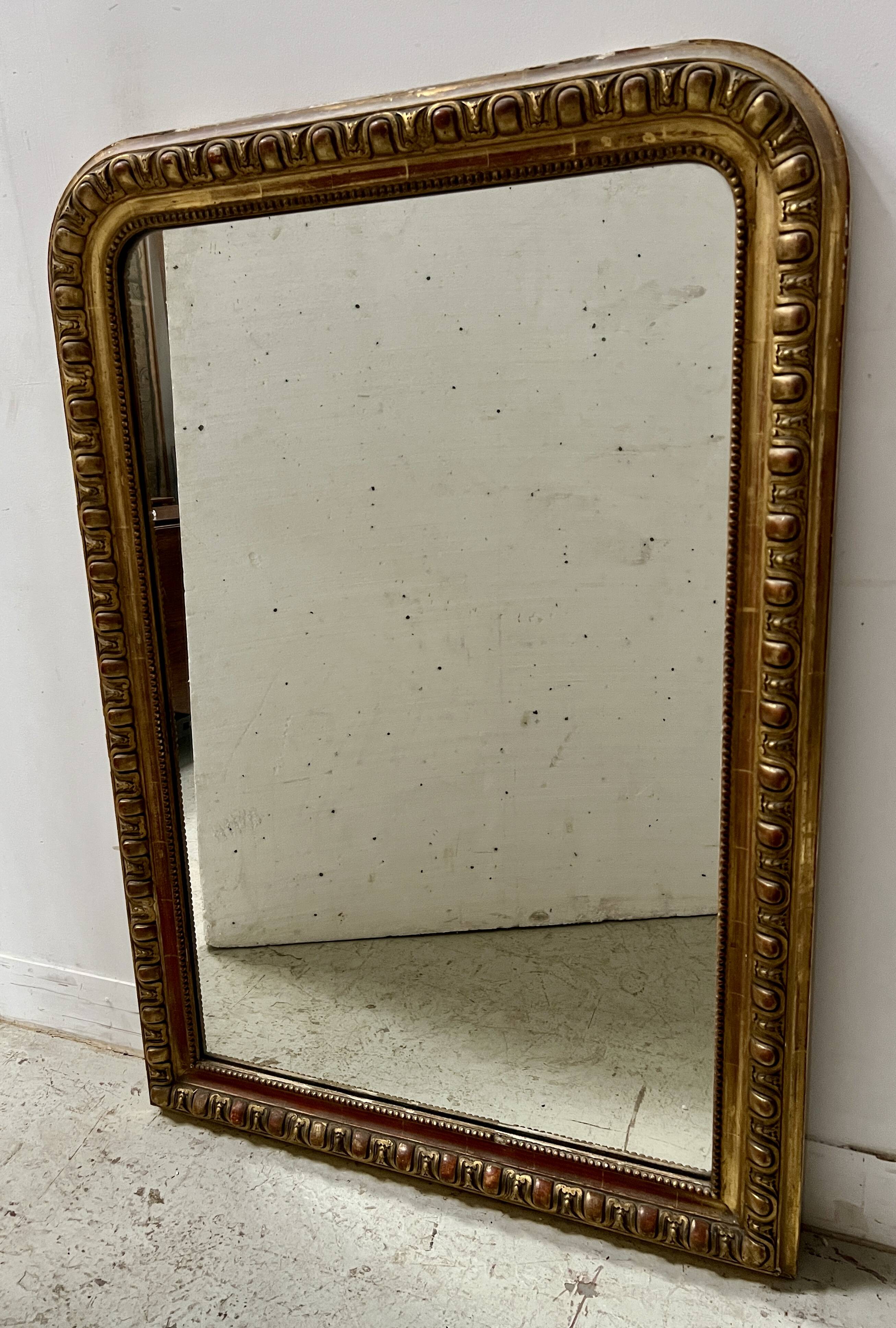 Louis Philippe gadrooned mirror in wood and gilt stucco, 19th century