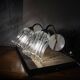 Pair of wall sconces in brass with transparent tulip glass shade.